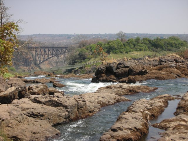 thezambeziriverabout40mbeforefallingdownvictoriafallsbothbridgesareafterthefalls.jpg