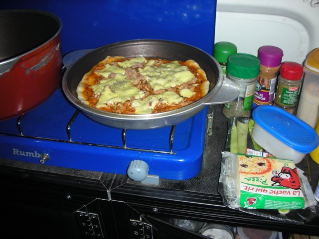 victoriamadepizzafordinnerinthecarwithherspecialovenlikepotfromargentina.jpg